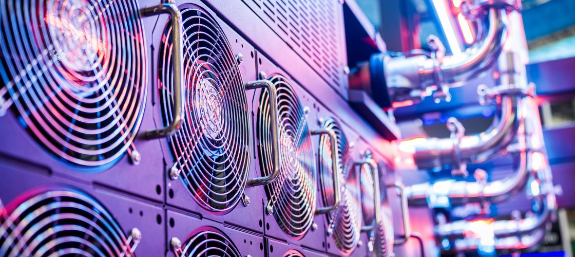 Rows of servers under blue and magenta light