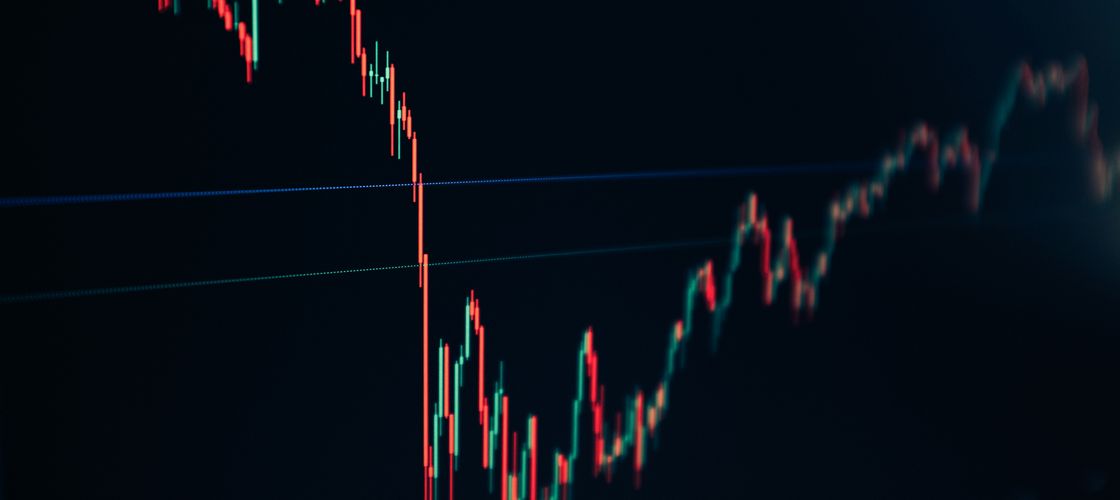 A candlestick chart falling sharply, then recovering